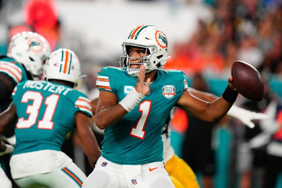 Week 7: Miami Dolphins quarterback Tua Tagovailoa throws a pass while sporting his team's throwback look against the Pittsburgh Steelers at Hard Rock Stadium. The Dolphins won the game, 16-10.