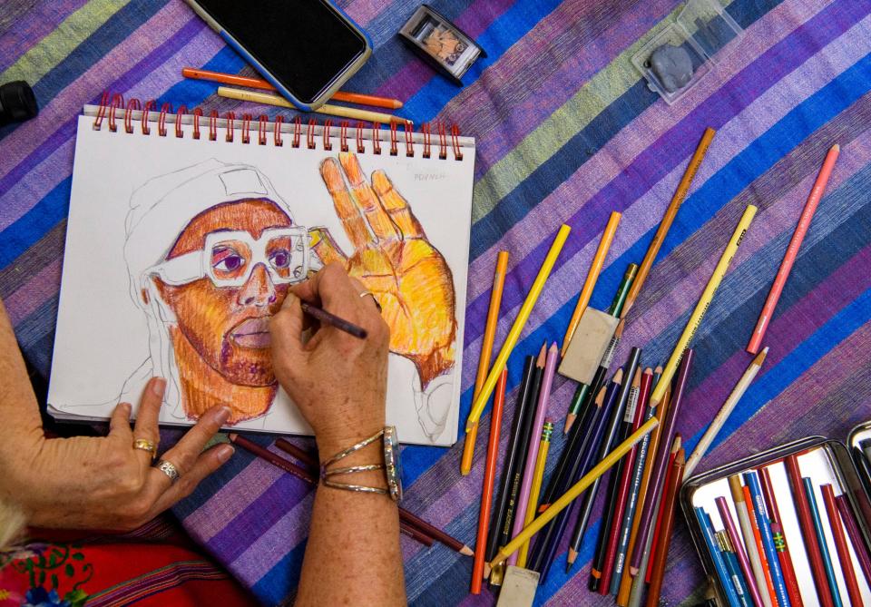 Bess Lee works on her colored pencil portrait of PDVNCH during the Bloomington Portrait Group's session with the artist at The Vault at Gallery Mortgage on Oct. 28.