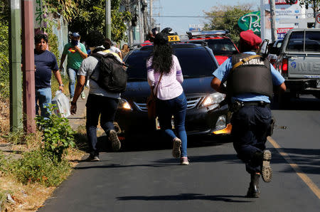 A police officer dislodge demonstrators during a protest against the government of Nicaragua's President Daniel Ortega in Managua, Nicaragua March 16, 2019. REUTERS/Oswaldo Rivas