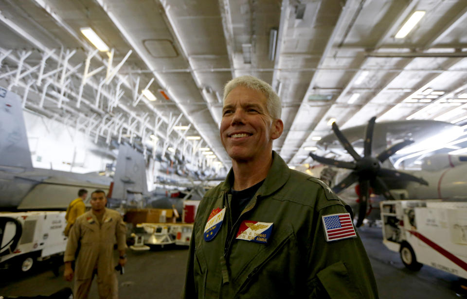 Rear Admiral Karl Thomas, Task Force 70/Commander, Carrier Strike Group 5, poses before an E-2 Hawkeye plane following a media interview aboard the U.S. aircraft carrier USS Ronald Reagan off South China Sea Tuesday, Aug. 6, 2019, west of the Philippines. The USS Ronald Reagan is cruising in international waters in the South China Sea amid tensions in the disputed islands, shoals and reefs between China and other claimant-countries as Philippines, Vietnam and Malaysia. (AP Photo/Bullit Marquez)