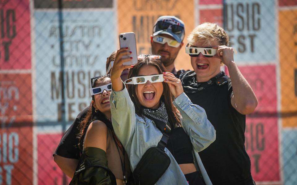 ACL Fest-goers take a selfie as they wait for the eclipse on Oct. 14 at Zilker Park.