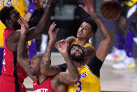 Los Angeles Lakers' Anthony Davis (3) and P.J. Tucker, left, reach for the ball during the first half of an NBA conference semifinal playoff basketball game Thursday, Sept. 10, 2020, in Lake Buena Vista, Fla. (AP Photo/Mark J. Terrill)