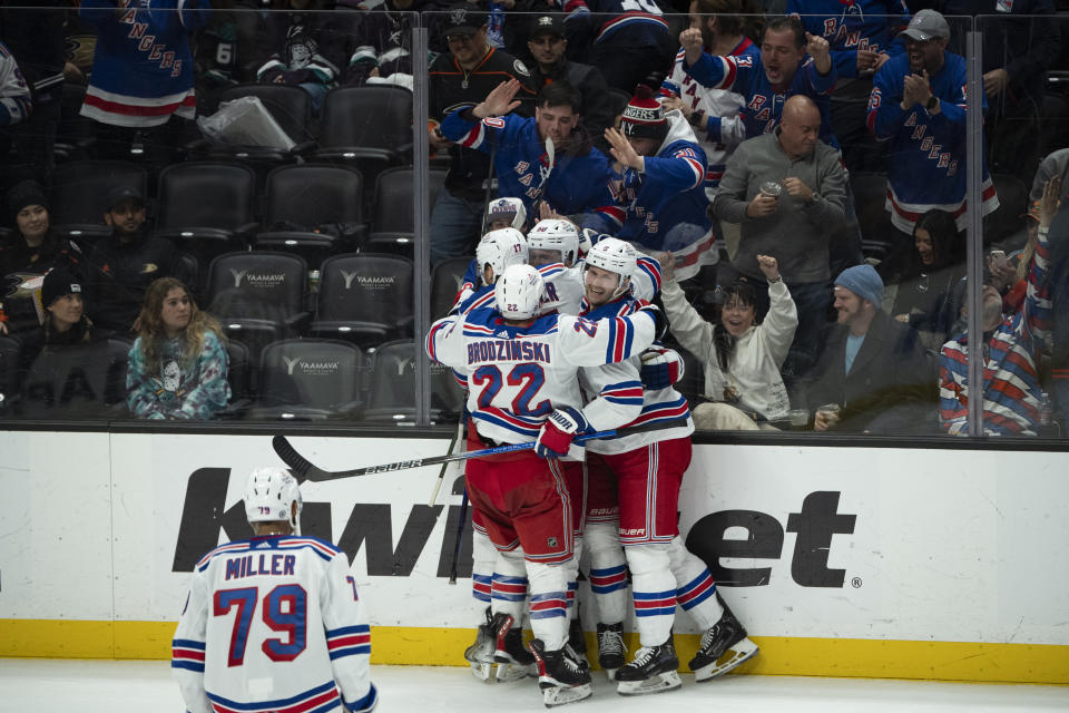 New York Rangers players celebrate after a goal by left wing Will Cuylle (50) during the third period of an NHL hockey game against the Anaheim Ducks, Sunday, Jan. 21, 2024, in Anaheim, Calif. (AP Photo/Kyusung Gong)