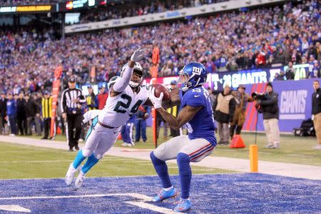 Dec 20, 2015; East Rutherford, NJ, USA; New York Giants wide receiver Odell Beckham Jr. (13) catches a touchdown pass in front of Carolina Panthers corner back Josh Norman (24) during the fourth quarter at MetLife Stadium. The Panthers defeated the Giants 38-35. Mandatory Credit: Brad Penner-USA TODAY Sports