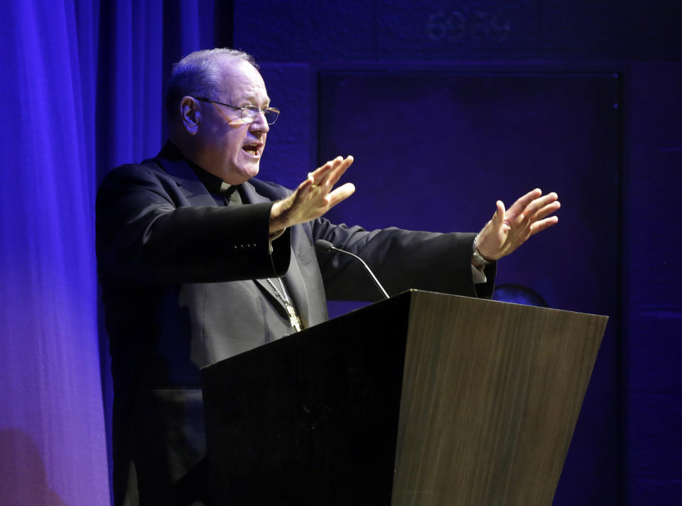 Cardinal Timothy Dolan, the Catholic archbishop for New York, gives a blessing during christening ceremonies, aboard the Norwegian Cruise Line's new ship, Norwegian Breakaway, in New York, Wednesday, May 8, 2013. The ship is themed on New York City, with a colorful mural on the exterior hull design by pop artist Peter Max featuring the city skyline and the Statue of Liberty. (AP Photo/Richard Drew)