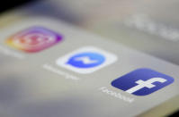 FILE – In this March 13, 2019, file photo, Facebook, Messenger and Instagram apps are displayed on an iPhone, in New York. Two years ago, Apple threatened to pull Facebook and Instagram from its app store over concerns about the platform being used as a tool to trade and sell maids in the Mideast. (AP Photo/Jenny Kane, File)