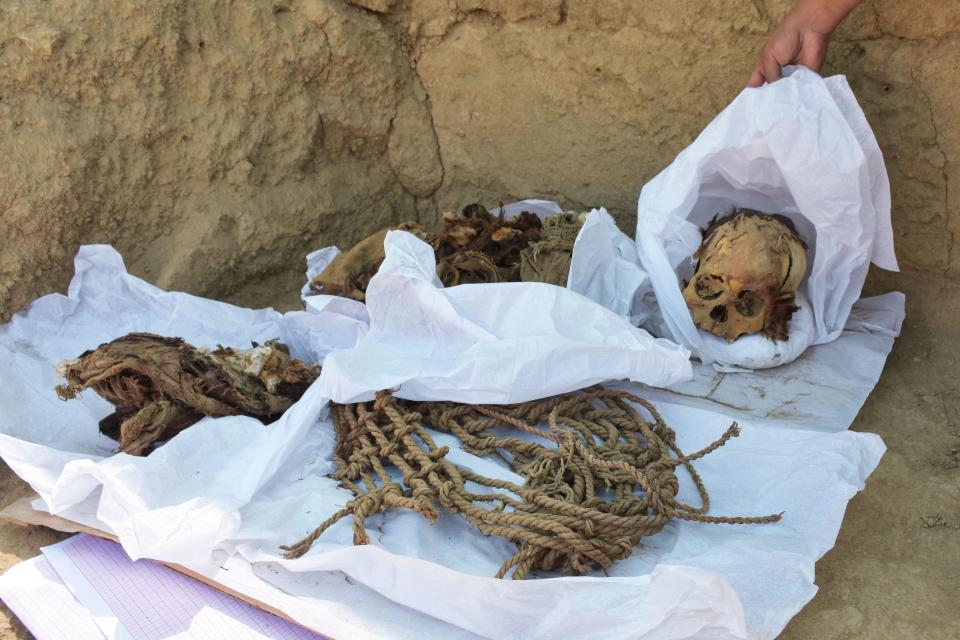 This undated handout picture relased by the Archeology Department of the San Marcos University shows the remains of a pre-Inca individual unearthed at the Cajamarquilla Archaeological Complex in Cajamarquilla, Peru. - Peruvian archaeologists discovered a pre-Inca mummy between 800 and 1,200 years old in perfect condition, while they were excavating at an ancient mud urban center on the outskirts of Lima, those responsible for the find reported Tuesday. The remains are in perfect condition and belong to a teenager, who would have been about 12 or 13 years old with an approximate height of 1 meter 30 centimeters. (Photo by Handout / Archaeology Department of the San Marcos University / AFP)