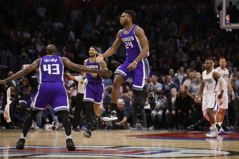 Sacramento Kings guard Buddy Hield, center, and forward Anthony Tolliver, left, celebrate after center Willie Cauley-Stein, rear second left, scored the go-ahead basket with 1.8 seconds left in an NBA basketball game against the Los Angeles Clippers, Sunday, March 26, 2017, in Los Angeles. The Kings won 98-97. (AP Photo/Danny Moloshok)