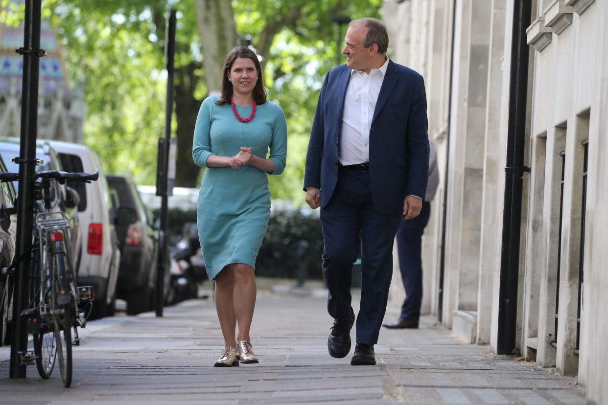 Liberal Democrat deputy leader Jo Swinson (L) and Liberal Democrat politician Ed Davey arrive to unveil an election poster slamming opposition Labour party leader Jeremy Corbyn for helping the Conservative party deliver Brexit rather than working to Stop Brexit, in central London on May 14, 2019. (Photo by Isabel Infantes / AFP)        (Photo credit should read ISABEL INFANTES/AFP/Getty Images)