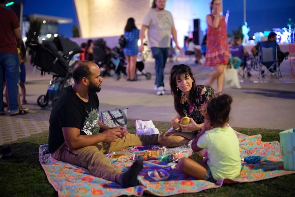 A family takes part in the September 2021 Color of Art event at Scissortail Park. Color of Art is a free, family-friendly series of events that combine local music, dance and visual art in an immersive community experience. The 2022 series starts May 22 at Scissortail Park.