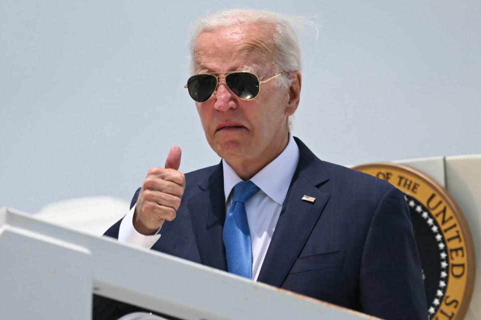 US president Joe Biden boards Air Force One as he departs Dover Air Force Base in Dover, Delaware, on 23 July 2024 (AFP via Getty Images)