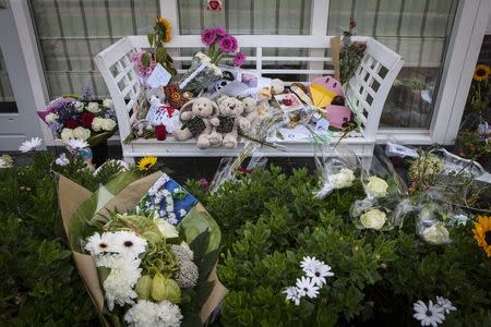 Flowers, toys and teddy bears are placed on a bench in front of the house of a family, who were all killed in Thursday's Malaysia Airlines Boeing 777 plane (flight MH17) crash, in Rosmalen July 19, 2014. REUTERS/Mischa Rapmund