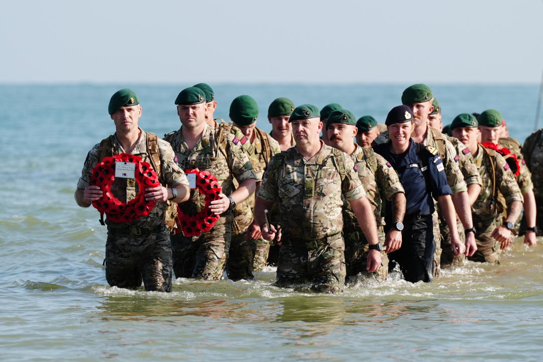 A beach landing by the Royal Marines of 47 Commando and civilians at Asnelles. (PA)