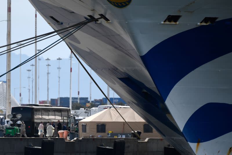 Medical professionals prepare to disembark passengers from the Grand Princess cruise ship, which is carrying passengers who have tested positive for coronavirus docked, at the Port of Oakland in Oakland