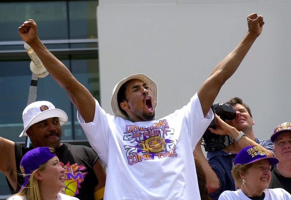 Los Angeles Lakers' guard Kobe Bryant gestures to the crowd from atop a doubledecker bus as the Lakers victory parade arrives at Staples Center in Los Angeles, June 21, 2000. Bryant, the 18-time NBA All-Star who won five championships and became one of the greatest basketball players of his generation during a 20-year career with the Los Angeles Lakers, died in a helicopter crash Sunday, Jan. 26, 2020. He was 41. (AP Photo/Nick Ut)