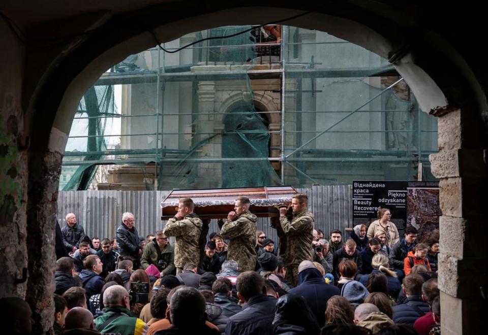 <div class="inline-image__caption"><p>Servicemen carry a coffin during the funeral ceremony of Yuriy Dadak-Ruf and Taras Kryt in Lviv on April 9.</p></div> <div class="inline-image__credit">Viacheslav Ratynskyi/Reuters</div>