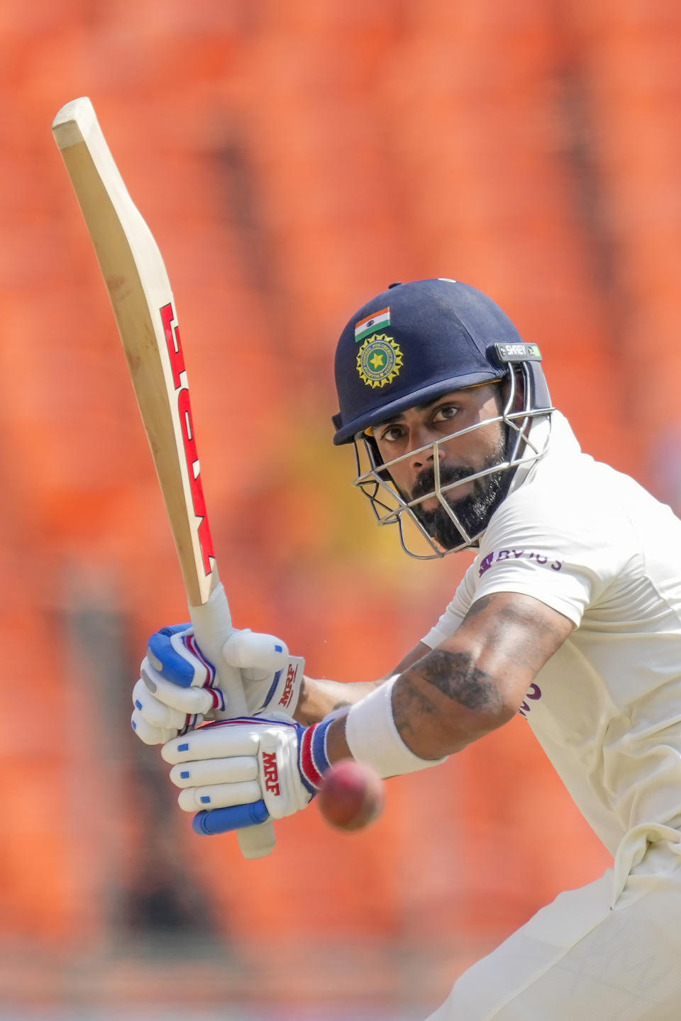 India's Virat Kohli watches the ball after playing a shot during the fourth day of the fourth cricket test match between India and Australia in Ahmedabad, India, Sunday, March 12, 2023. (AP Photo/Ajit Solanki)