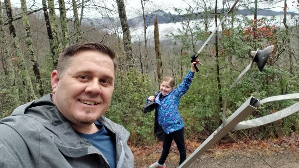 Marc Newland and his daughter Erica, 10, clean up trash in the Great Smoky Mountains National Park.