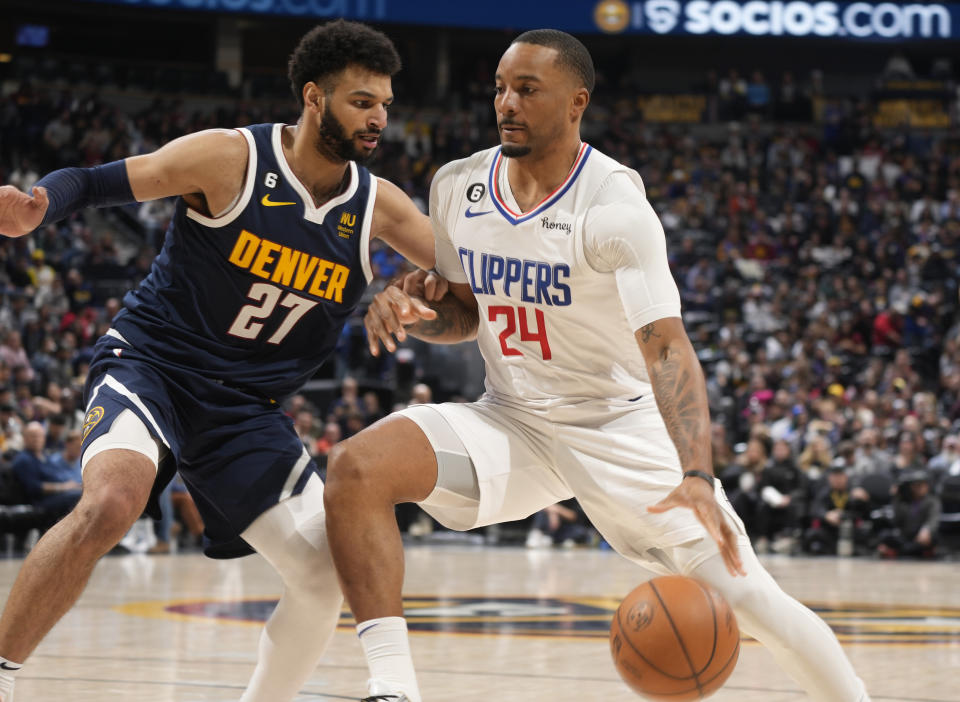 Los Angeles Clippers forward Norman Powell, right, drives as Denver Nuggets guard Jamal Murray defends during the second half of an NBA basketball game Thursday, Jan. 5, 2023, in Denver. (AP Photo/David Zalubowski)