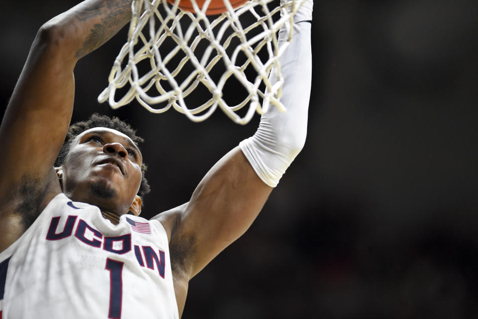 Connecticut's Christian Vital (1) dunks to put the team ahead during the second half of an NCAA college basketball game against South Florida Sunday, Feb. 23, 2020, in Storrs, Conn. (AP Photo/Stephen Dunn)