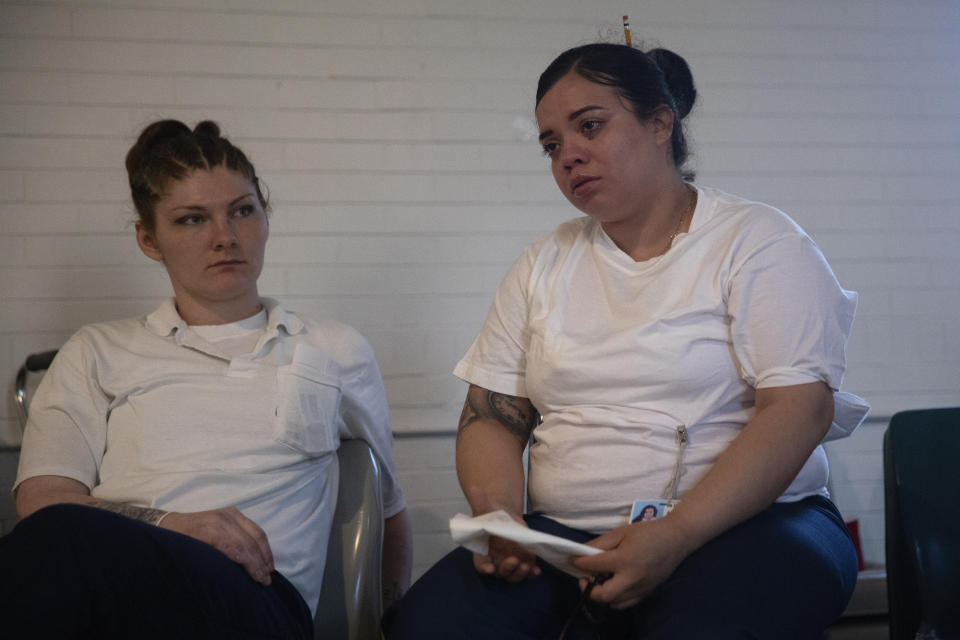Crystal Martinez, right, breaks down as she talks about her own experience with domestic violence after a screening of the film "And So I Stayed" at Logan Correctional Center Wednesday, June 8, 2022, in Lincoln, Ill. The film — which documents efforts to pass a law in New York that allows survivors of gender-based violence to present the abuse they suffered as consideration for new, shorter sentences — was being shown for the first time to an audience inside a correctional facility, and specifically to people who had been convicted of serious crimes they argue were related to abuse. (Erin Hooley/Chicago Tribune via AP)