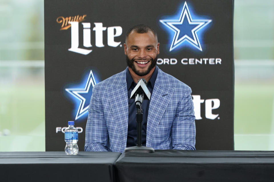 Dallas Cowboys quarterback Dak Prescott smiles during a news conference at the team's NFL football practice facility in Frisco, Texas, Wednesday, March 10, 2021. The Cowboys and Prescott have finally agreed on the richest contract in club history, two years after negotiations began with the star quarterback. (AP Photo/LM Otero)