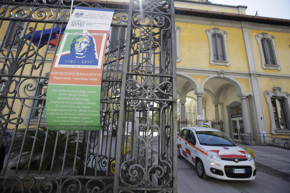 FILE - In this April 14, 2020 file photo, a car gets out of the Pio Albergo Trivulzio eldercare facility, in Milan, Italy. As Italy prepares to emerge from the West’s first and most extensive coronavirus lockdown, it is increasingly becoming apparent that something went terribly wrong in Lombardy, the hardest-hit region in Europe’s hardest-hit country. Lombardy registered more dead in nursing homes than any other region, nearly half of the 6,773 dead registered from Feb. 1-April 15, 40% of whom were either positive or had COVID-19 symptoms, according to a survey of the Superior Institutes of Health. (AP Photo/Luca Bruno, file)
