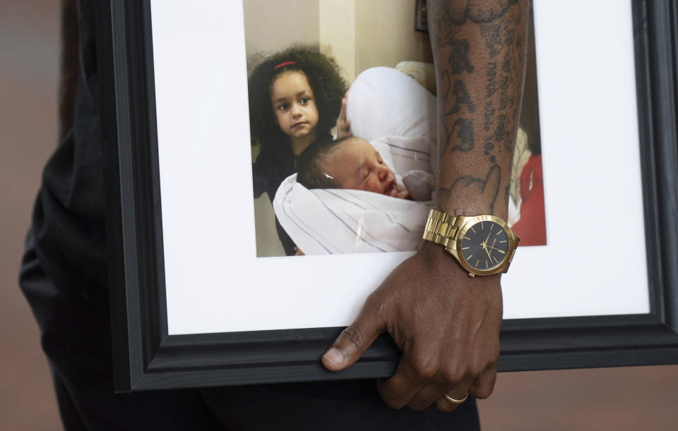 Trinity Ottoson-Smith's father Raishawn Smith, holds his favorite photo of her as he speaks about his daughter outside the courtroom Tuesday, July 11, 2023, in Minneapolis. Robinson was sentenced Tuesday to more than 37 years in prison for fatally shooting the 9-year-old Minnesota girl as she was jumping on a trampoline with friends. Robinson pleaded guilty in March to second-degree murder in the 2021 death of Ottoson-Smith. (Glen Stubbe/Star Tribune via AP)