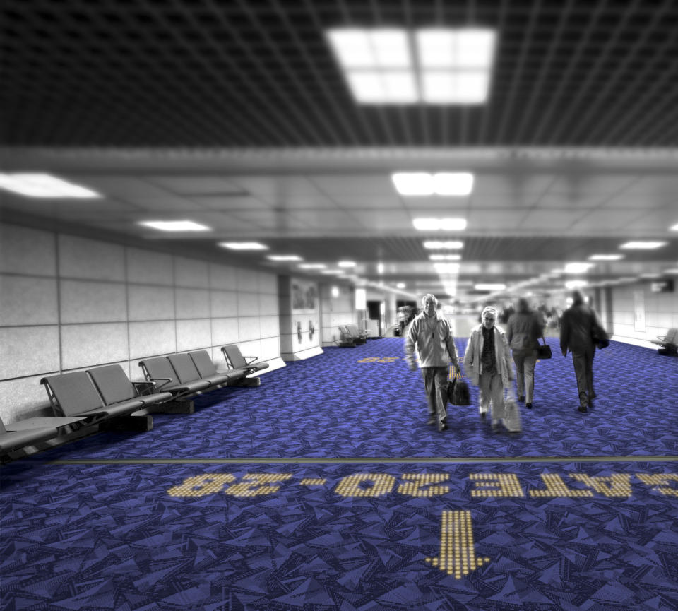 In this computer-generated image made available by Royal Philips NV, Monday, Nov. 18, 2013, an LED sign in a carpet indicates a boarding gate in a fictional airport environment. That option is on its way as two European companies, Philips and carpet-maker Desso have developed a system in which colored LEDs are combined with specialized carpets to make tailored hotel signs or directions to airport boarding gates that appear underfoot instead of on walls. (AP Photo/Philips)