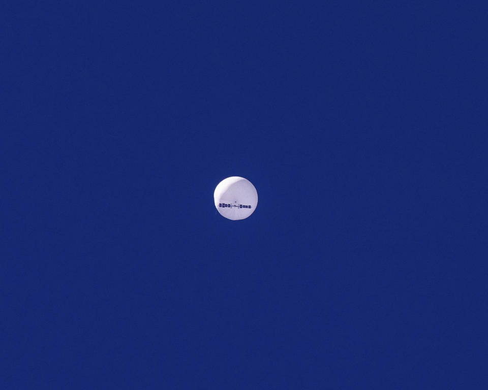 In this photo provided by Chad Fish, a large balloon drifts above the Atlantic Ocean, just off the coast of South Carolina, Saturday, Feb. 4, 2023. The balloon was struck by a missile from an F-22 fighter just off Myrtle Beach, fascinating sky-watchers across a populous area known as the Grand Strand for its miles of beaches that draw retirees and vacationers. (Chad Fish via AP)