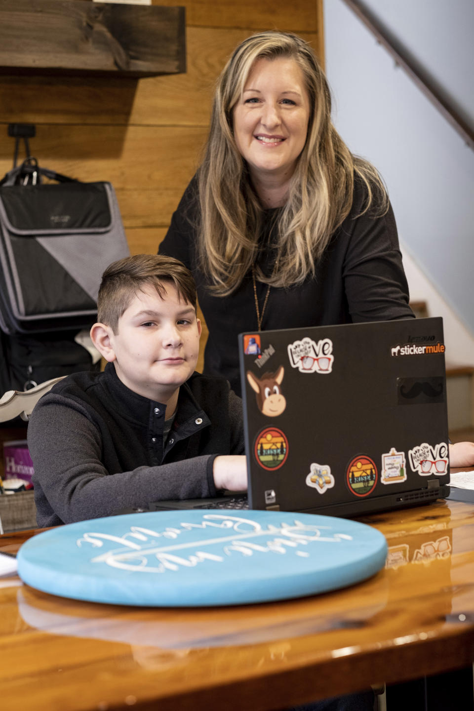 Kelli Rivera is photographed with her son Tate, 11 at their home in Roswell, Ga., Friday, Feb. 12, 2021. Rivera is hoping a voucher bill passes that will help pay for her to move her son out of a public Cobb County school and into a private school. (AP Photo/Ben Gray)