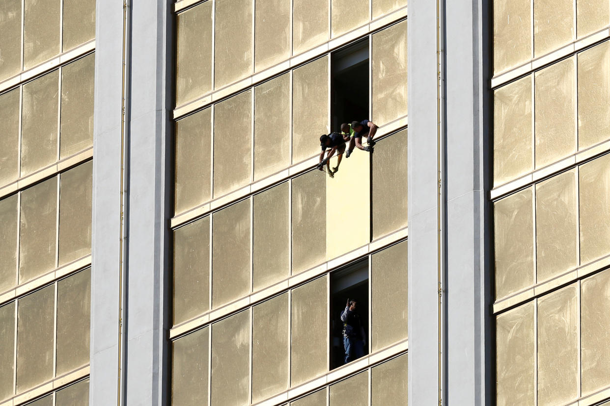 Workers board up a broken window at the Mandalay Bay hotel on Oct. 6, where Stephen Paddock killed 58 people and wounded more than 500 in Las Vegas days before. (Photo: Chris Wattie/Reuters)