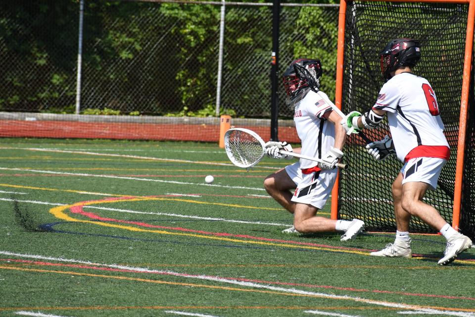 Haddonfield junior goalie Ryan Foley smothers a New Providence shot