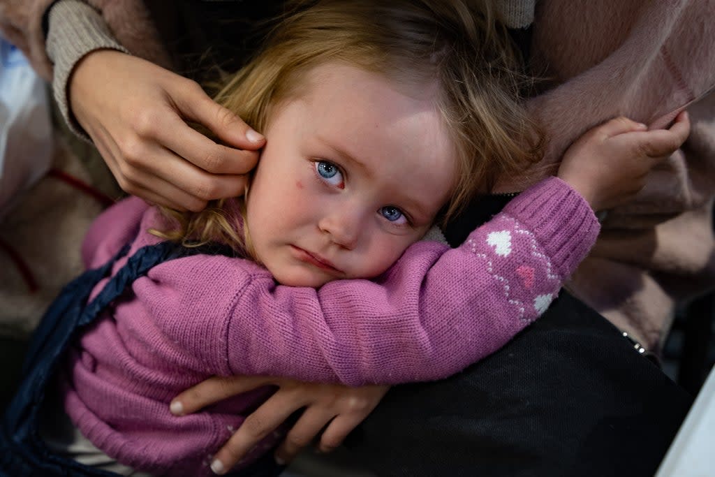 Paulina, 2, is comforted by her sister after fleeing intense shelling in Mariupol  (Bel Trew)