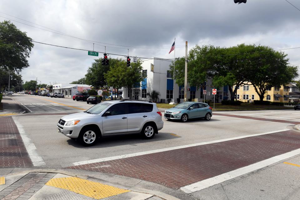 Cars pass through the intersection of State Road 60 and 14th Avenue on Monday, March 29, 2021, in downtown Vero Beach.