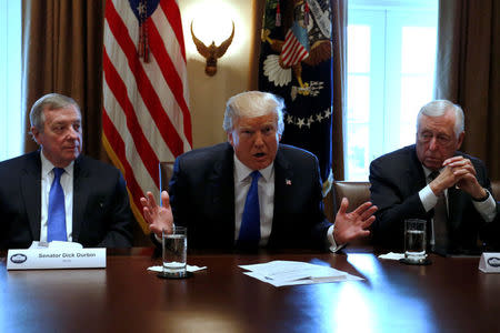 U.S. President Donald Trump, flanked by U.S. Senator Dick Durbin (D-IL) and Representative Steny Hoyer (D-MD), holds a bipartisan meeting with legislators on immigration reform at the White House in Washington, U.S. January 9, 2018. REUTERS/Jonathan Ernst