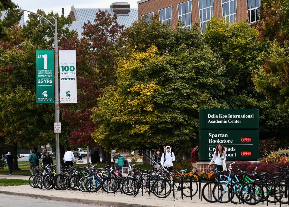 Students near the Delia Koo International Academic Center on the campus of Michigan State University, Thursday, Oct. 13, 2022.