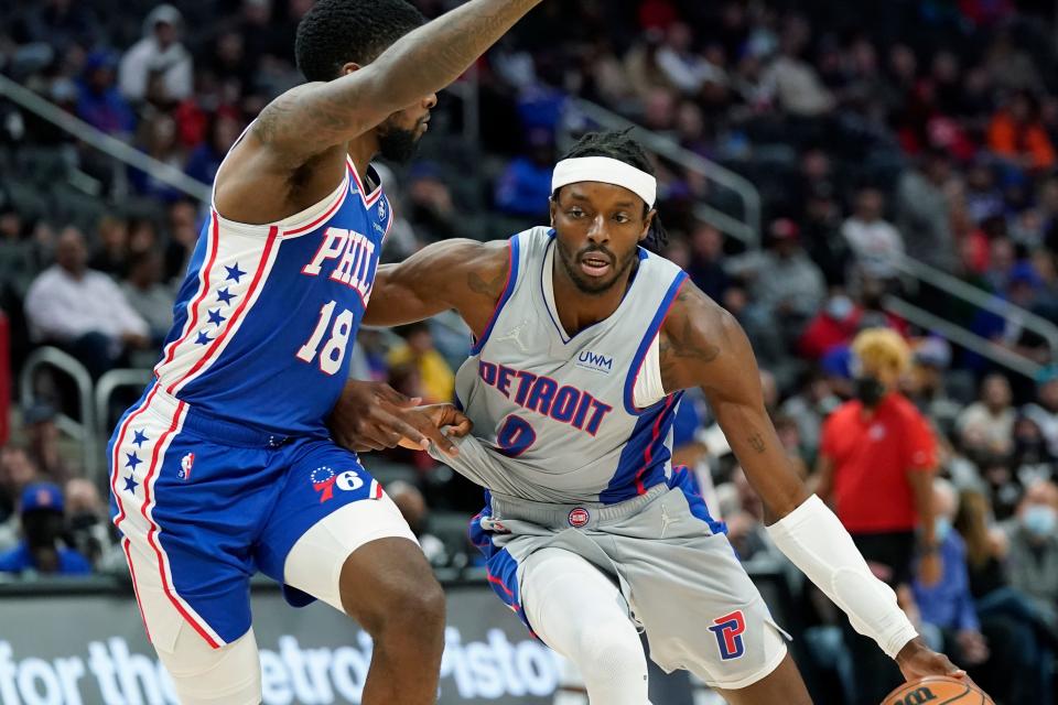 Detroit Pistons forward Jerami Grant (9) drives as Philadelphia 76ers guard Shake Milton (18) defends during the first half of an NBA basketball game, Thursday, Nov. 4, 2021, in Detroit.