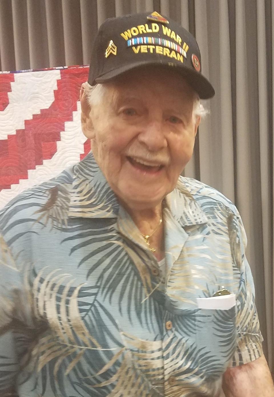 Crawford Shearer served in the Battle of the Bulge. Here, he is receiving a Quilt of Valor at the Henderson County Library.