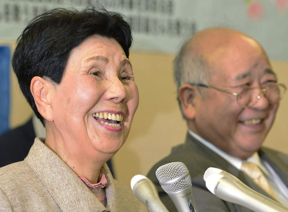 Hideko Hakamada, sister of inmate Iwao Hakamada, has all smiles as she speaks during a press conference in Shizuoka, central Japan, Thursday, March 27, 2014 after the Shizuoka District Court decided to reopen a high-profile murder case in which Hakamada has been on death row for more than 30 years. The court on Thursday suspended the death sentence for 78-year-old Hakamada and ordered him released after 48 years behind bars. Guinness World Records lists him the longest-serving death row inmate. The court says DNA analysis obtained by his lawyers suggests investigators fabricated evidence. At right is lead lawyer Katsuhiko Nishijima. (AP Photo/Kyodo News) JAPAN OUT, MANDATORY CREDIT
