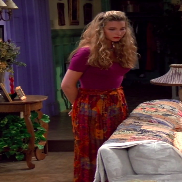 Phoebe wearing a tight shirt, a maxi skirt, and sandals