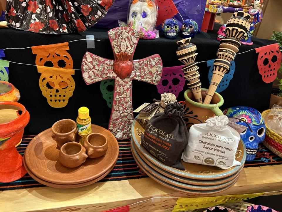 Items for sale at Colores Mexicanos that you can put on an ofrenda like a cross, hot chocolate and mini Tajín.<p>Alani Vargas/Parade</p>