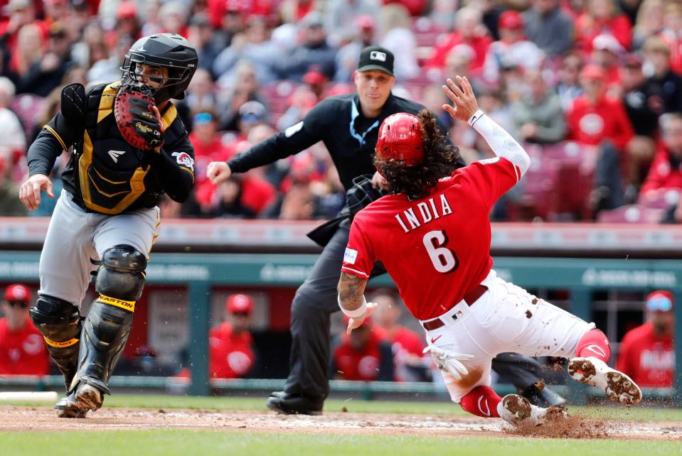 Apr 2, 2023; Cincinnati, Ohio, USA; Cincinnati Reds second baseman Jonathan India (6) scores against Pittsburgh Pirates catcher Austin Hedges (18) during the third inning at Great American Ball Park.