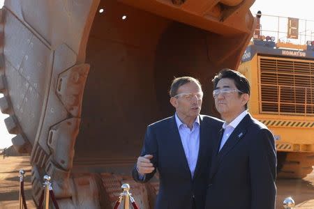 Australian Prime Minister Tony Abbott and Japanese Prime Minister Shinzo Abe are pictured during a tour of the Rio Tinto West Angelas iron ore mine in the Pilbara region of Western Australia, July 9, 2014. REUTERS/Alan Porritt/Pool