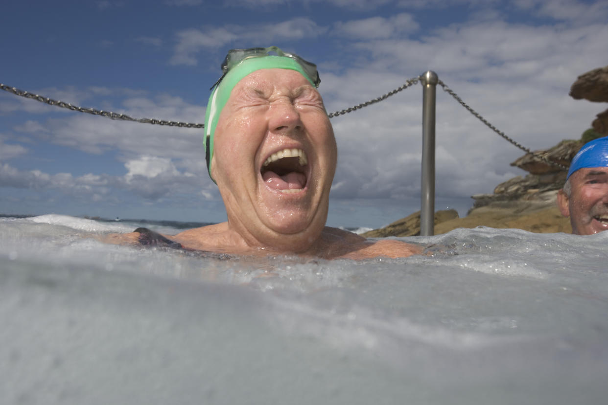 Senior woman in infinity pool, laughing, close-up