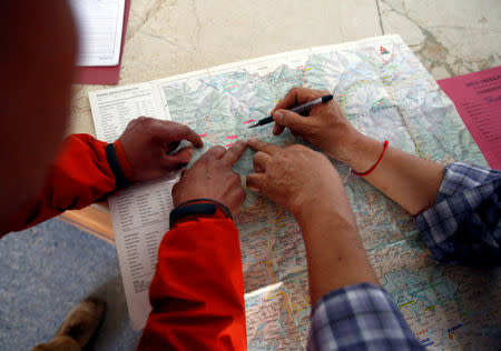 Rescue personnel from Asian Trekking shows the place on the map where Liang Sheng Yueh and Liu Chen Chun were found, in Kathmandu, Nepal April 26, 2017. Liang Sheng Yueh and his fellow trekker Liu Chen Chun who died, were missing for 47 days while on their trek. REUTERS/Navesh Chitrakar