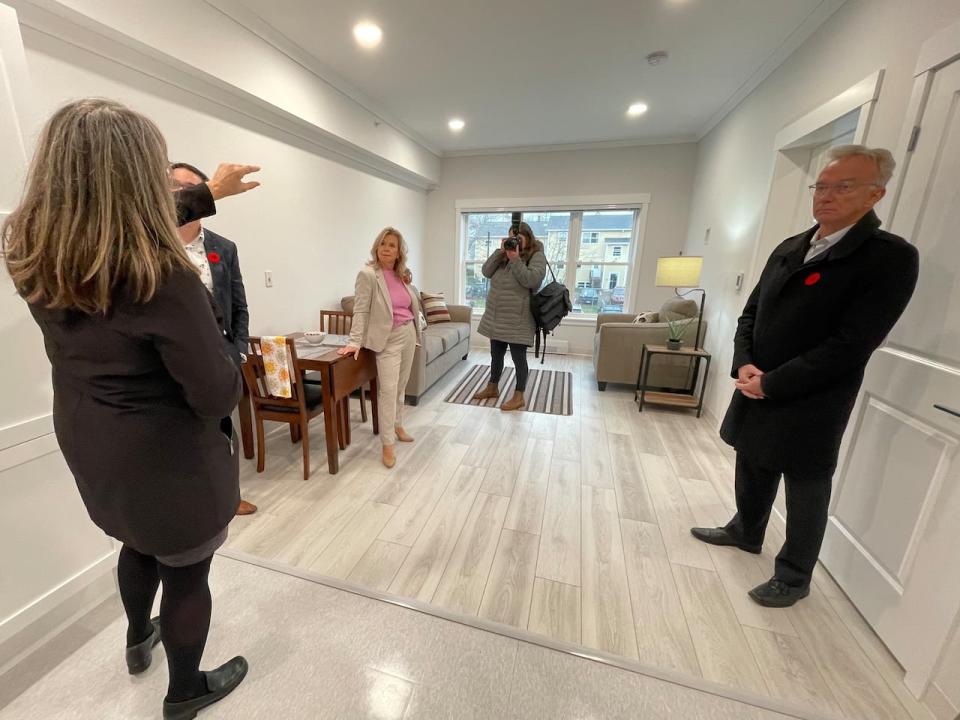 Officials show off a bachelor unit in the new complex. It is roughly 300 square feet. The small footprint is another way rent is being kept low.