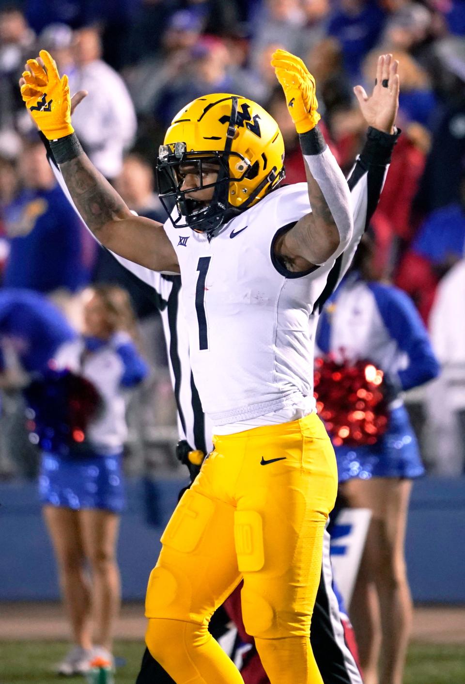 West Virginia wide receiver Winston Wright Jr. celebrates a touchdown during the second quarter of an NCAA college football against the Kansas game Saturday, Nov. 27, 2021, in Lawrence, Kan. (AP Photo/Ed Zurga)