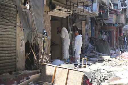 Forensic inspectors examine the site of the two explosions that occured on Thursday in the southern suburbs of the Lebanese capital Beirut, November 13, 2015. REUTERS/Aziz Taher