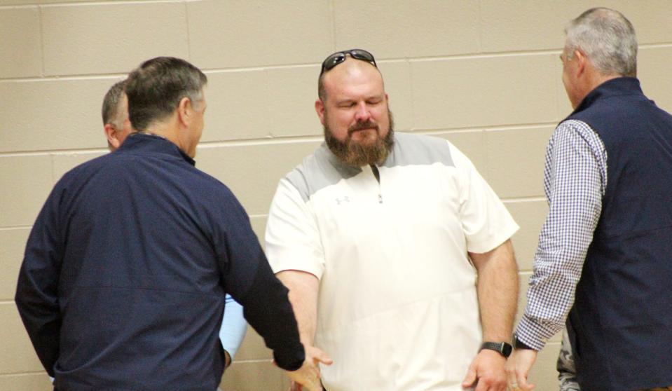 New Bartlesville High head football coach Harry Wright is greeted by well-wishers during Tuesday's home varsity basketball game. Wright, a product of Eufaula High and former Bacone College All-American, becomes the 11th head coach in the 40-year history of Bruin football.